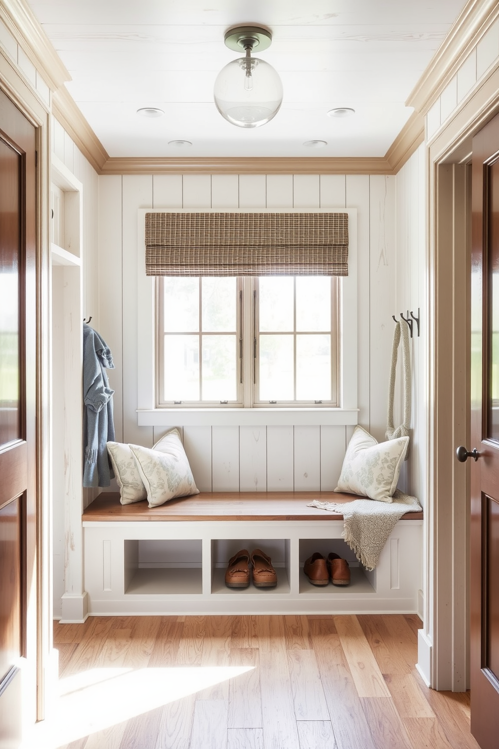 Light fixtures with vintage charm. The room is illuminated by ornate pendant lights featuring Edison bulbs and intricate metalwork. White mudroom design ideas. The space includes built-in benches with soft cushions and wall-mounted hooks for coats, all set against a backdrop of crisp white shiplap walls.