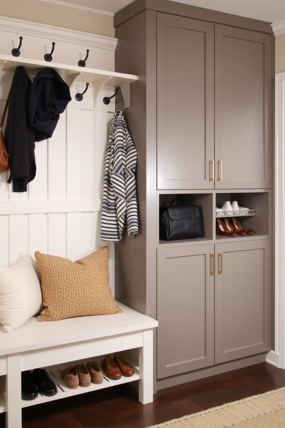 A stylish mudroom featuring a combination of open and closed storage solutions. The space includes a bench with plush cushions and hooks above for hanging coats, while sleek cabinets provide concealed storage for shoes and accessories.