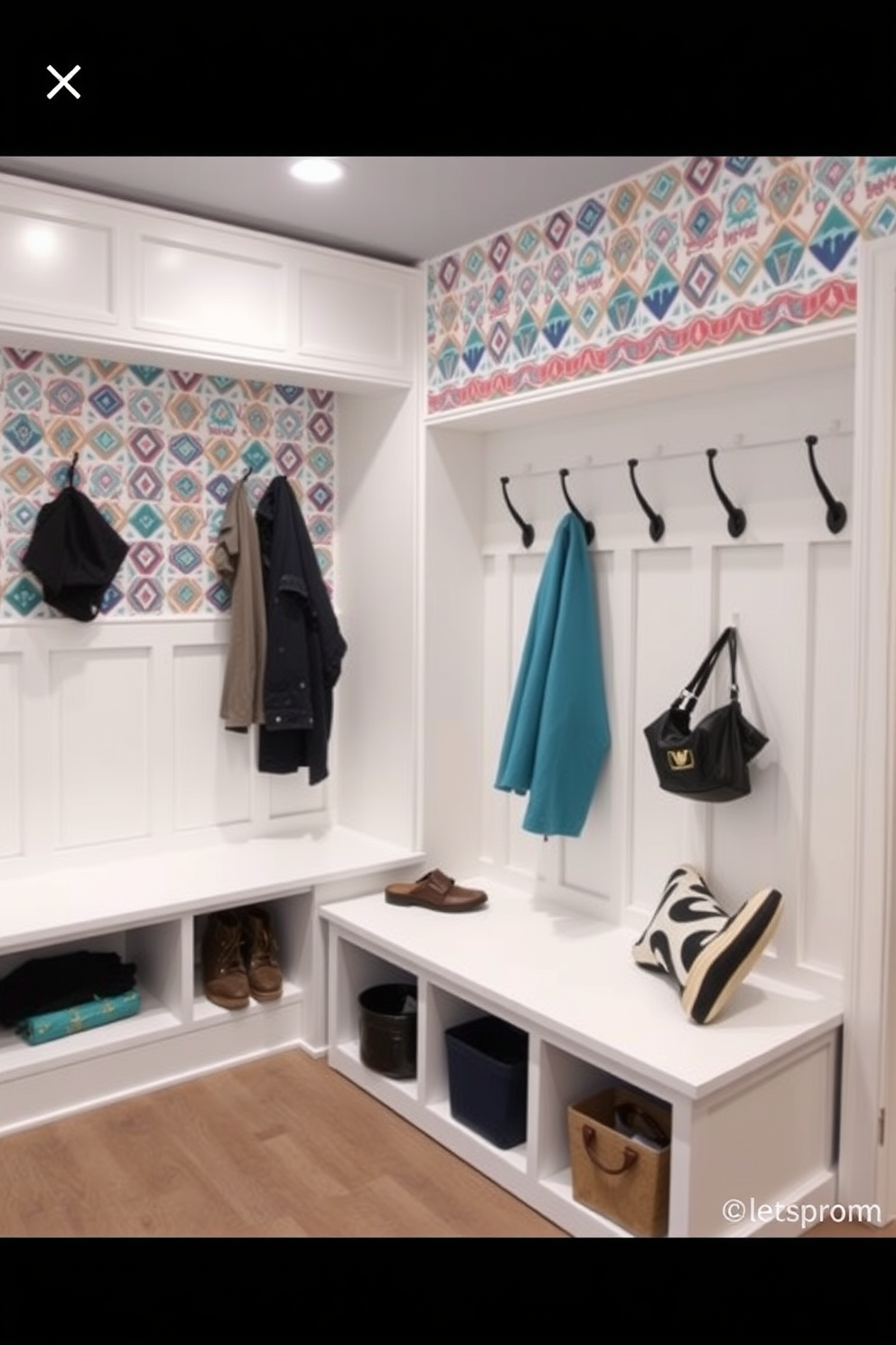 Accent wall with fun wallpaper design. The wall features a vibrant geometric pattern that adds a playful touch to the space. White mudroom design ideas. The room includes built-in benches with storage cubbies and hooks for coats, all in a clean white finish.