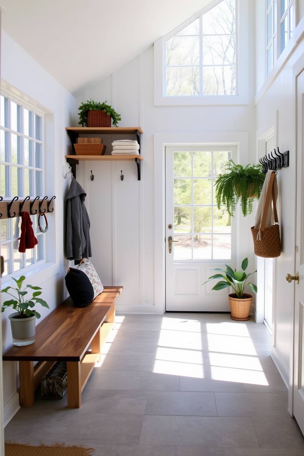 A bright and airy mudroom featuring large windows that allow natural light to flood the space. The walls are painted in a soft white hue, complemented by a rustic wooden bench and open shelving for storage. The floor is adorned with durable tile that mimics the look of natural stone. Decorative hooks line the wall for hanging coats and bags, while potted plants add a touch of greenery to the inviting atmosphere.