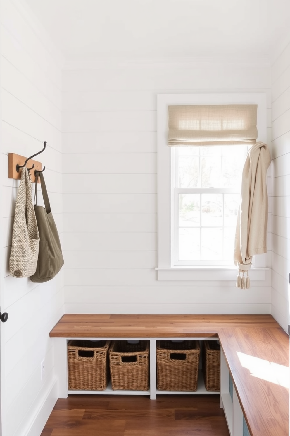 A charming farmhouse mudroom features shiplap walls painted in a soft white hue. Rustic wooden benches with woven baskets underneath provide ample storage and a cozy seating area. Natural light floods in through a large window adorned with simple linen curtains. A vintage coat rack made of reclaimed wood adds character and functionality to the space.