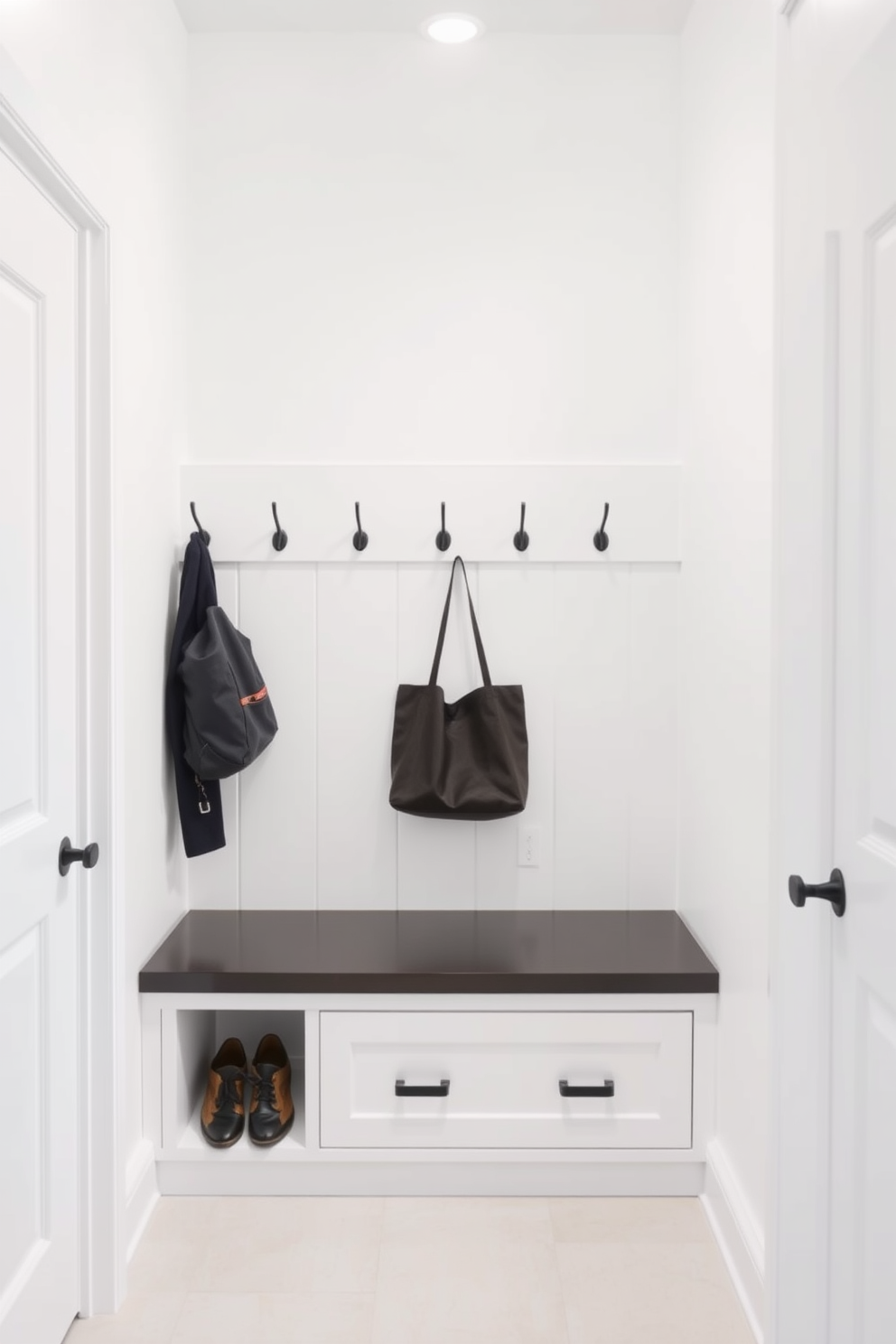 A spacious mudroom featuring a large mirror that reflects natural light and enhances the perception of space. The walls are painted in a soft white, complemented by built-in storage benches and hooks for coats and bags.