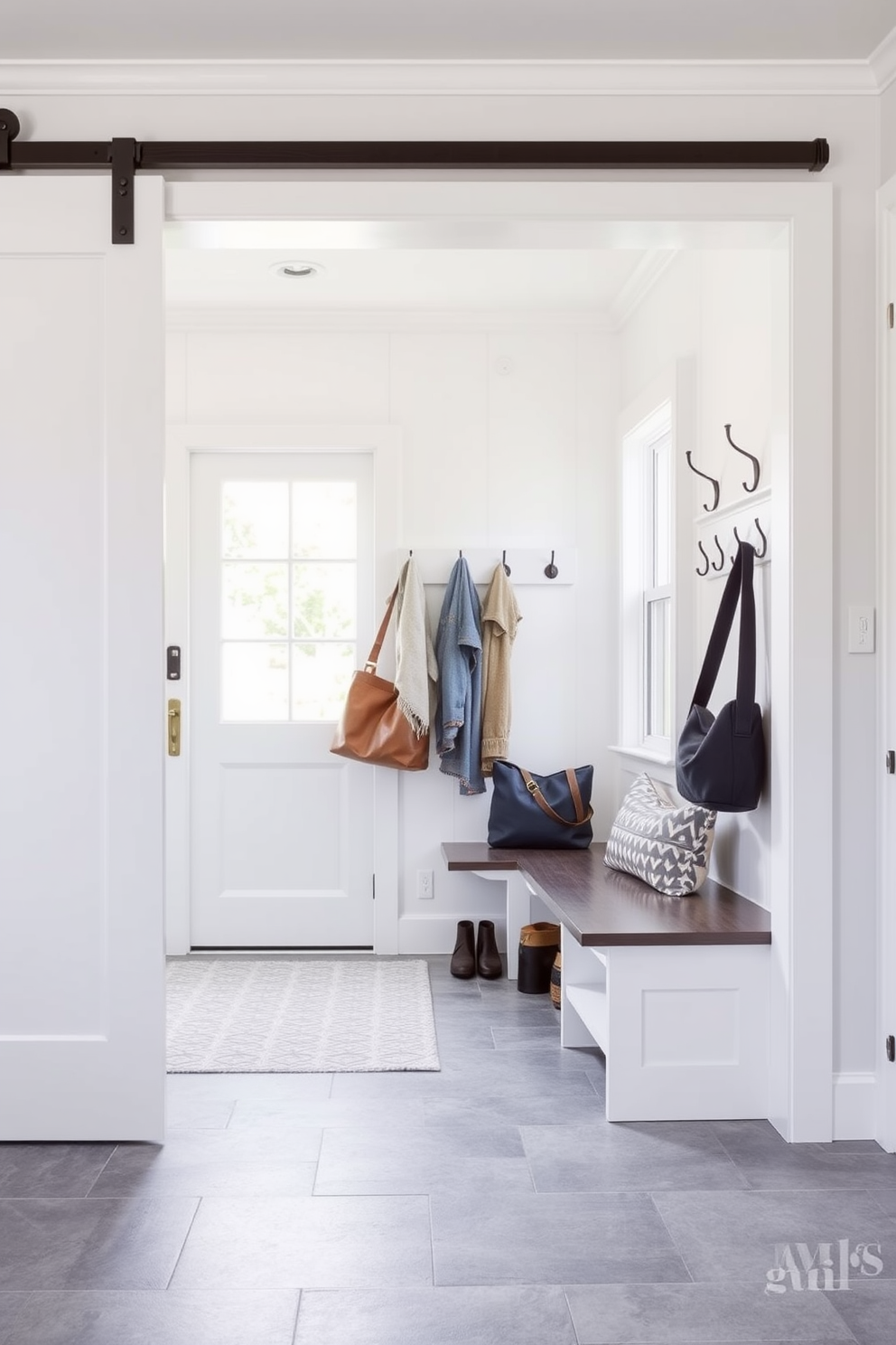 A bright and airy mudroom features natural wood accents that provide a warm contrast to the crisp white walls. The space includes built-in storage benches with soft cushions and hooks for hanging coats, creating an inviting and functional entryway.