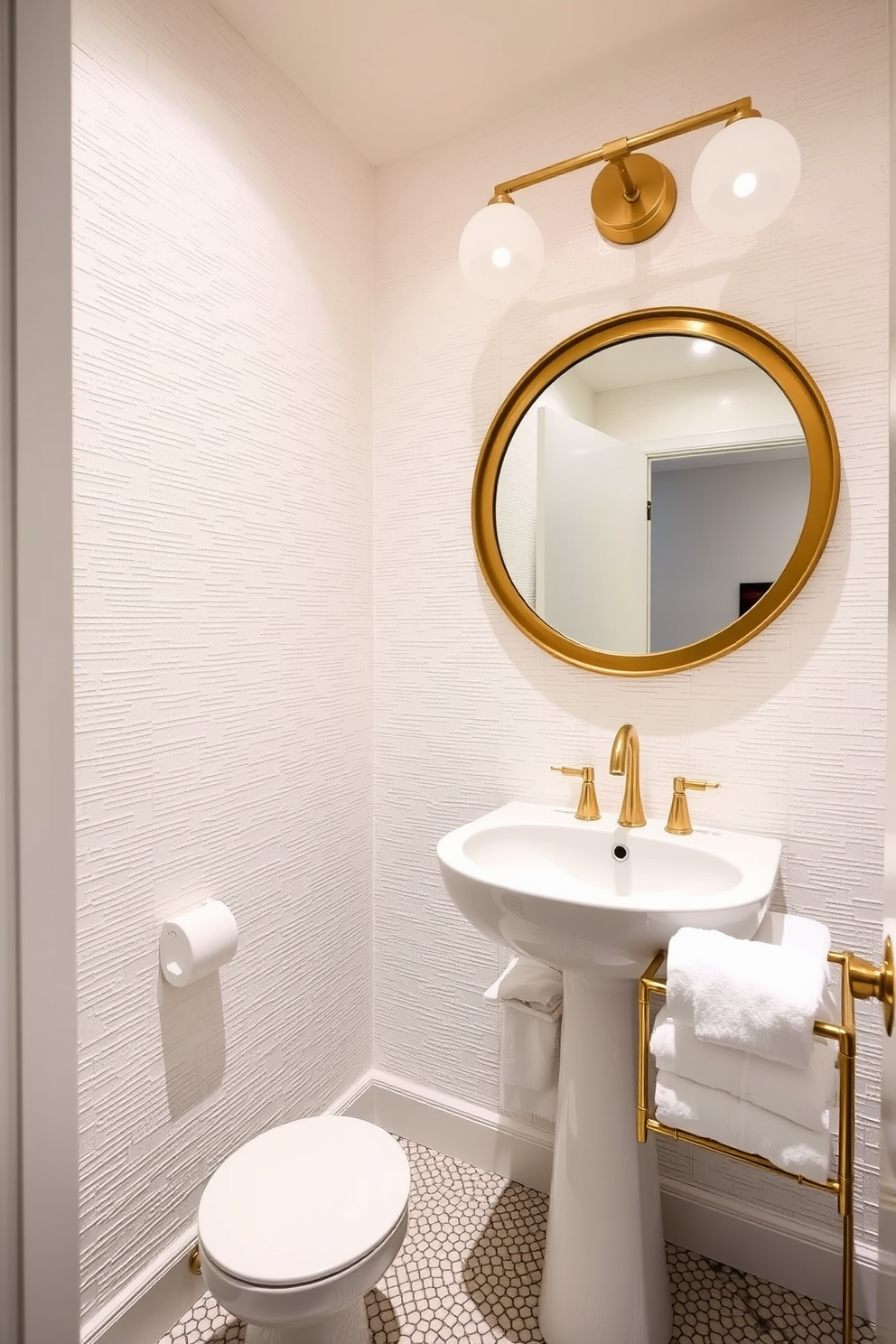 A chic powder room featuring a blend of textures for a dynamic design. The walls are adorned with textured wallpaper in a soft white hue, complemented by a sleek white pedestal sink. A large round mirror with a brushed gold frame hangs above the sink, reflecting the elegant lighting fixtures. The floor is covered with a mosaic tile that adds visual interest, while plush white towels are neatly displayed on a stylish rack.