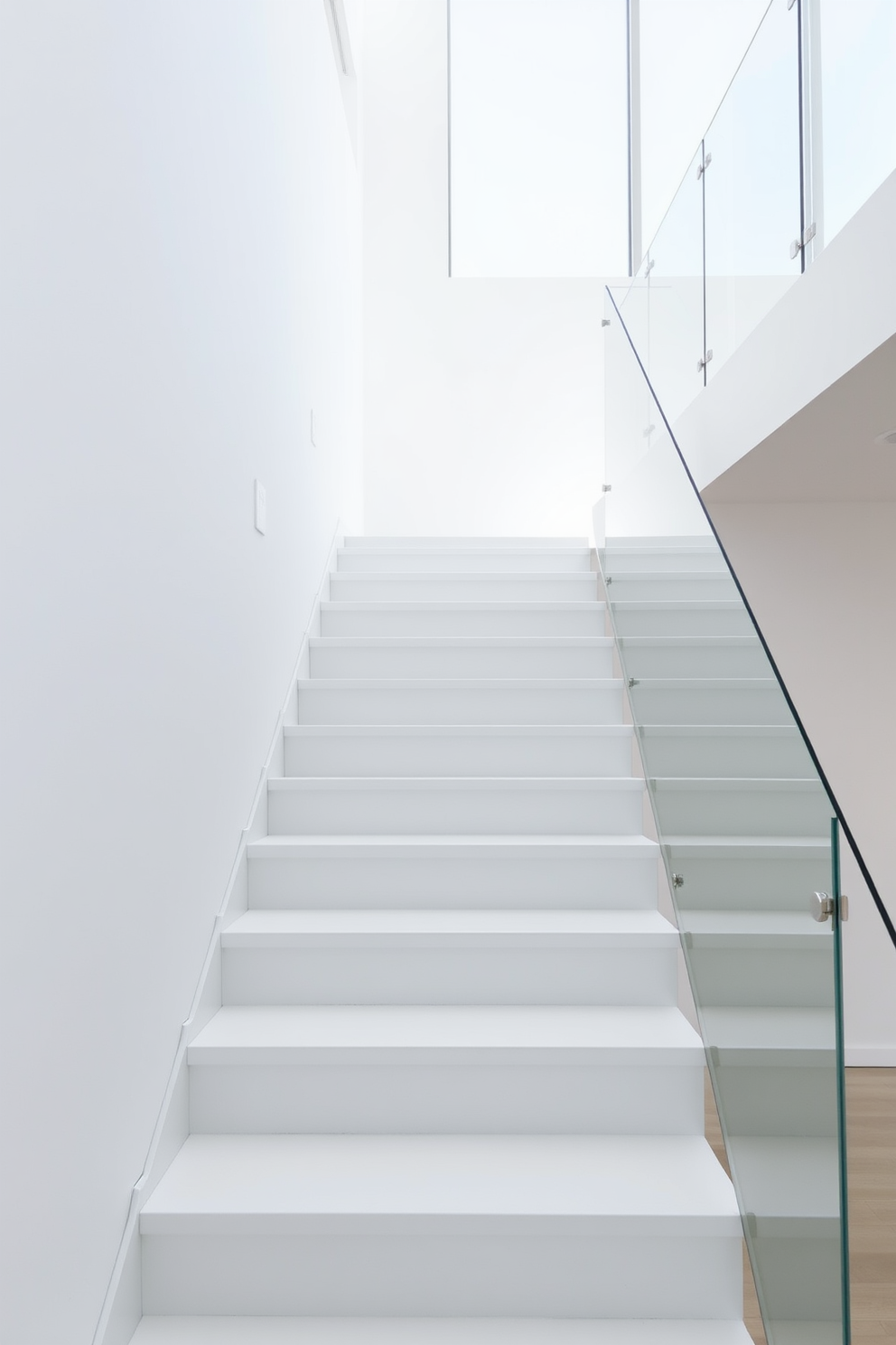 A stunning curved white staircase gracefully flows through the space, showcasing elegant wooden accents along the handrail. The staircase is illuminated by natural light streaming in from a large window, highlighting the smooth curves and inviting design.