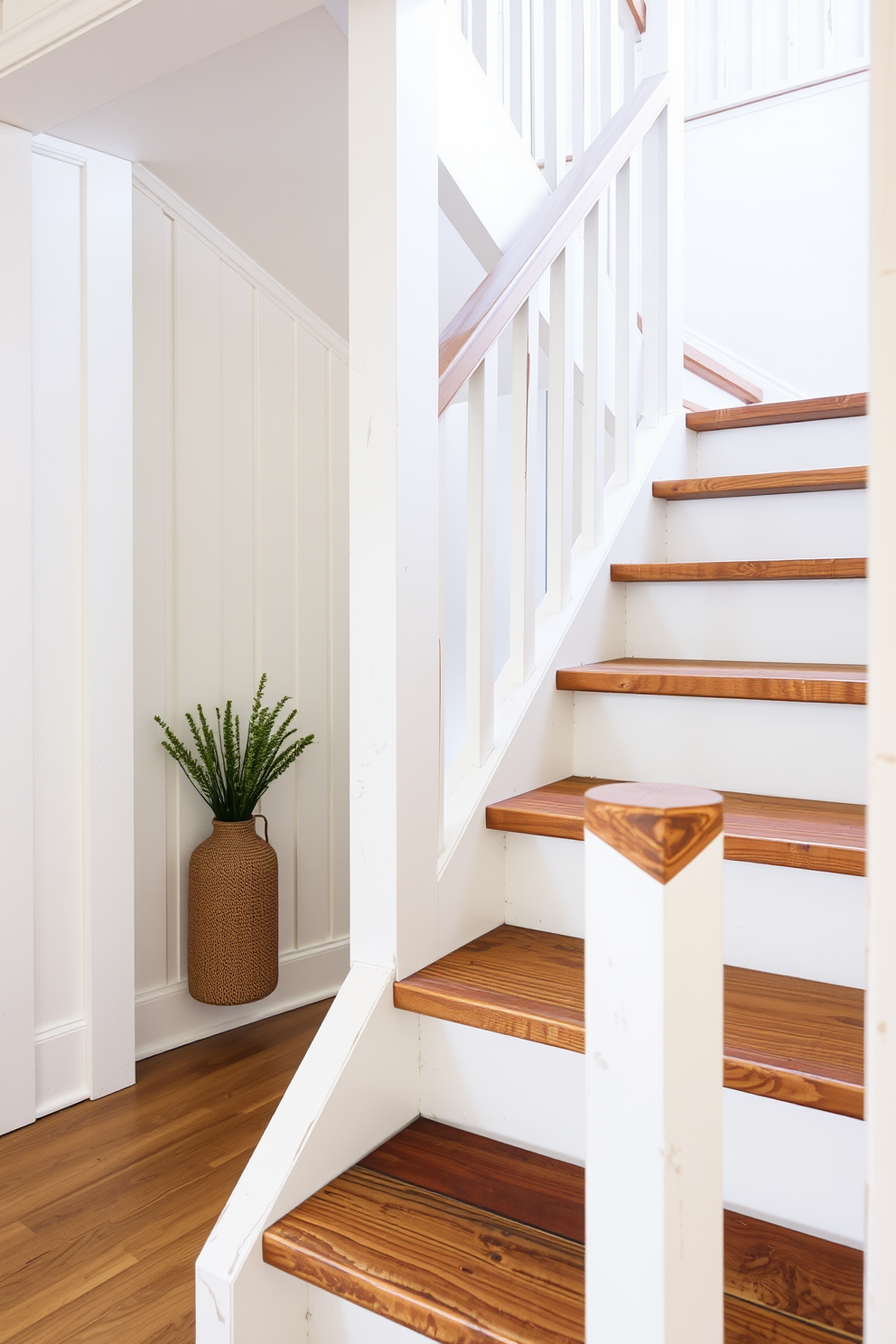 A contemporary white staircase elegantly ascends with sleek lines and a minimalist design. The steps are illuminated by subtle LED lighting, creating a warm and inviting ambiance. The handrail features a modern glass design, enhancing the airy feel of the space. Below the staircase, a small alcove is adorned with a potted plant, adding a touch of greenery to the overall aesthetic.