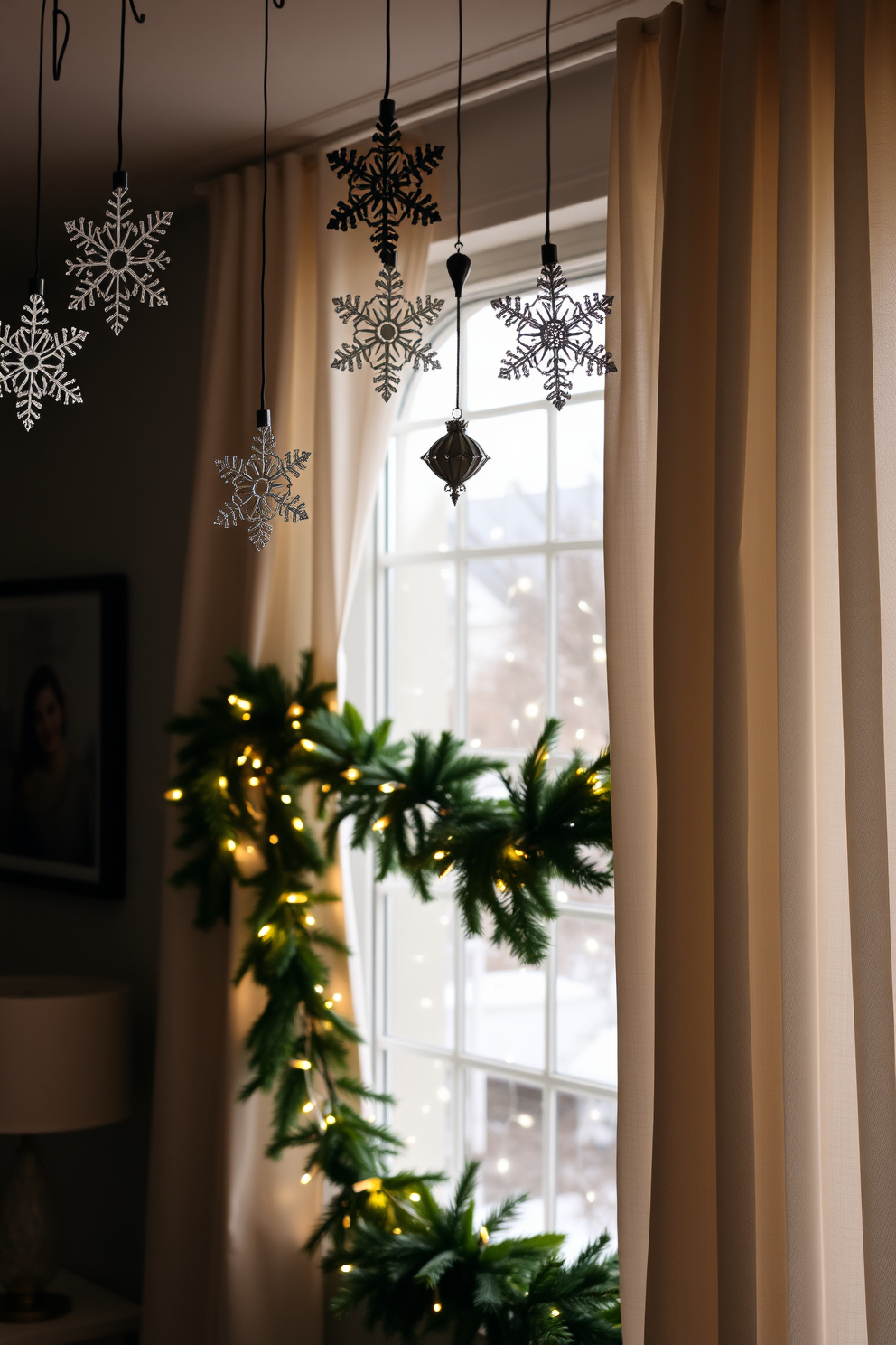 A cozy living room adorned with hanging snowflake ornaments from the ceiling. The ornaments glisten softly in the warm glow of the ambient lighting, creating a festive atmosphere. The window is beautifully decorated with a garland of evergreen branches intertwined with twinkling fairy lights. Sheer white curtains frame the window, allowing natural light to filter through while showcasing the cheerful holiday decor outside.