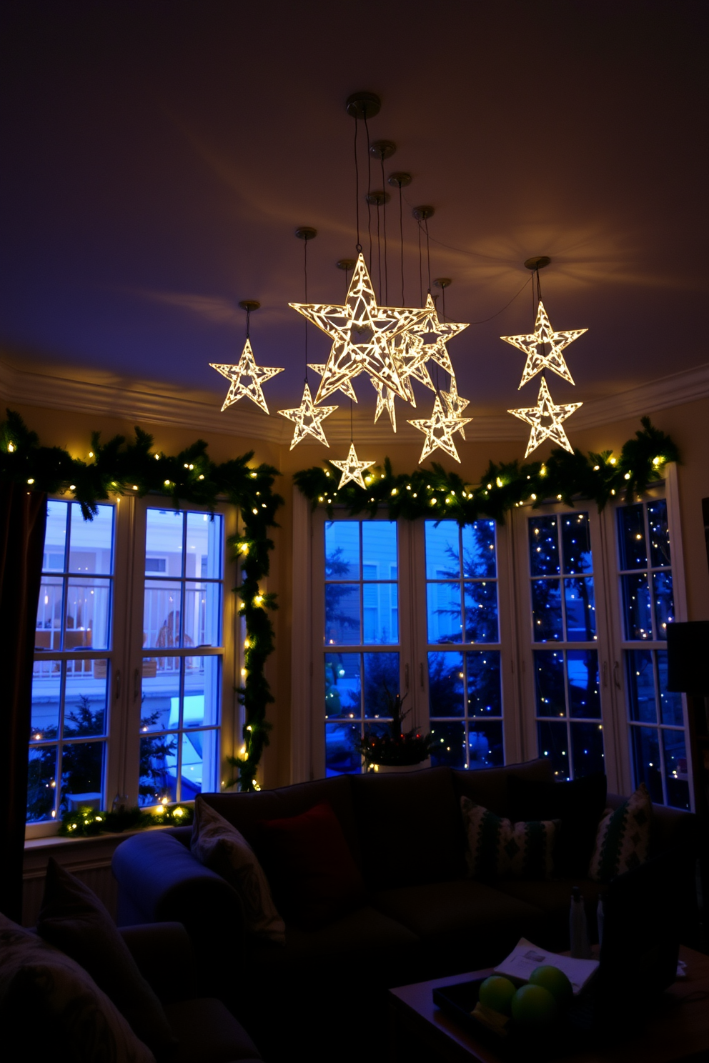 A cozy living room adorned with twinkling LED stars hanging from the ceiling creates a magical atmosphere. The windows are beautifully decorated with garlands of evergreen and twinkling fairy lights, enhancing the festive spirit.