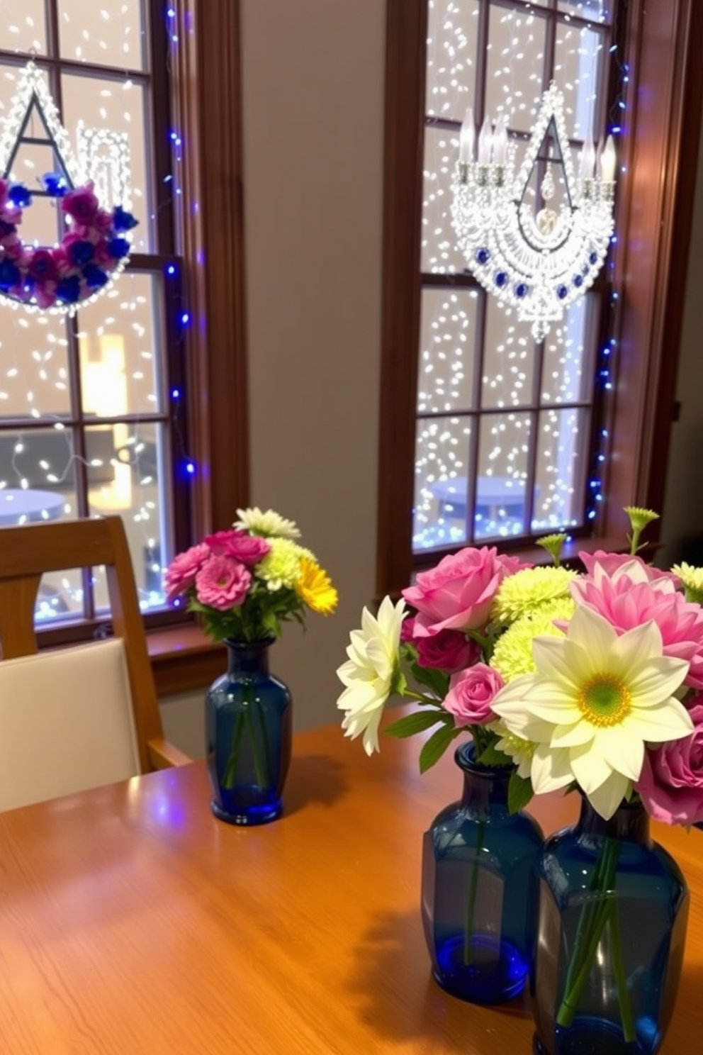 Fresh flowers are artfully arranged in elegant blue vases, adding a vibrant touch to the room. The vases are strategically placed on a wooden dining table, enhancing the overall aesthetic. For Hanukkah, the windows are adorned with beautiful decorations that reflect the spirit of the holiday. Soft blue and white lights twinkle, creating a warm and inviting atmosphere.