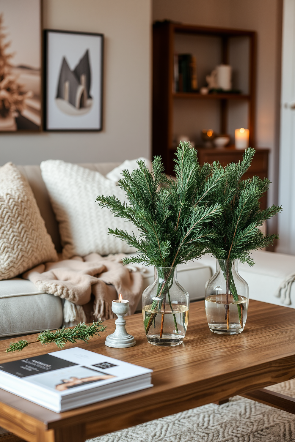 A cozy winter apartment setting adorned with evergreen branches in elegant vases. The vases are placed strategically on a wooden coffee table, creating a warm and inviting atmosphere. Soft, neutral-colored throw blankets and pillows are scattered across a plush sofa. A subtle glow from candles complements the natural greenery, enhancing the winter charm of the space.