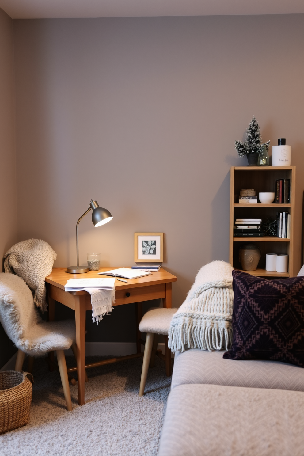 A cozy winter basement setting designed for productivity and relaxation. A small wooden desk is positioned against the wall, adorned with a stylish lamp and stationery for winter projects. The walls are painted in a warm gray hue, creating an inviting atmosphere. Plush seating with soft throws is arranged nearby, while a small bookshelf filled with winter-themed decor adds character to the space.