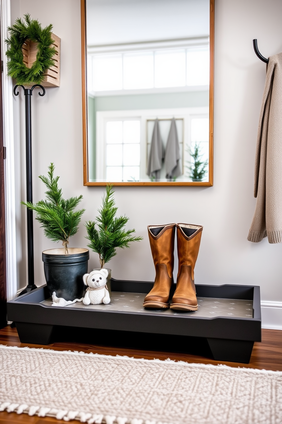 A stylish boot tray made of durable materials is positioned in a cozy winter entryway. The tray features a modern design with raised edges to contain mud and water, complemented by a soft, textured rug beneath it to add warmth to the space. Decorative elements such as potted evergreen plants and a chic coat rack enhance the winter theme. A large mirror above the boot tray reflects natural light, making the entryway feel inviting and spacious.