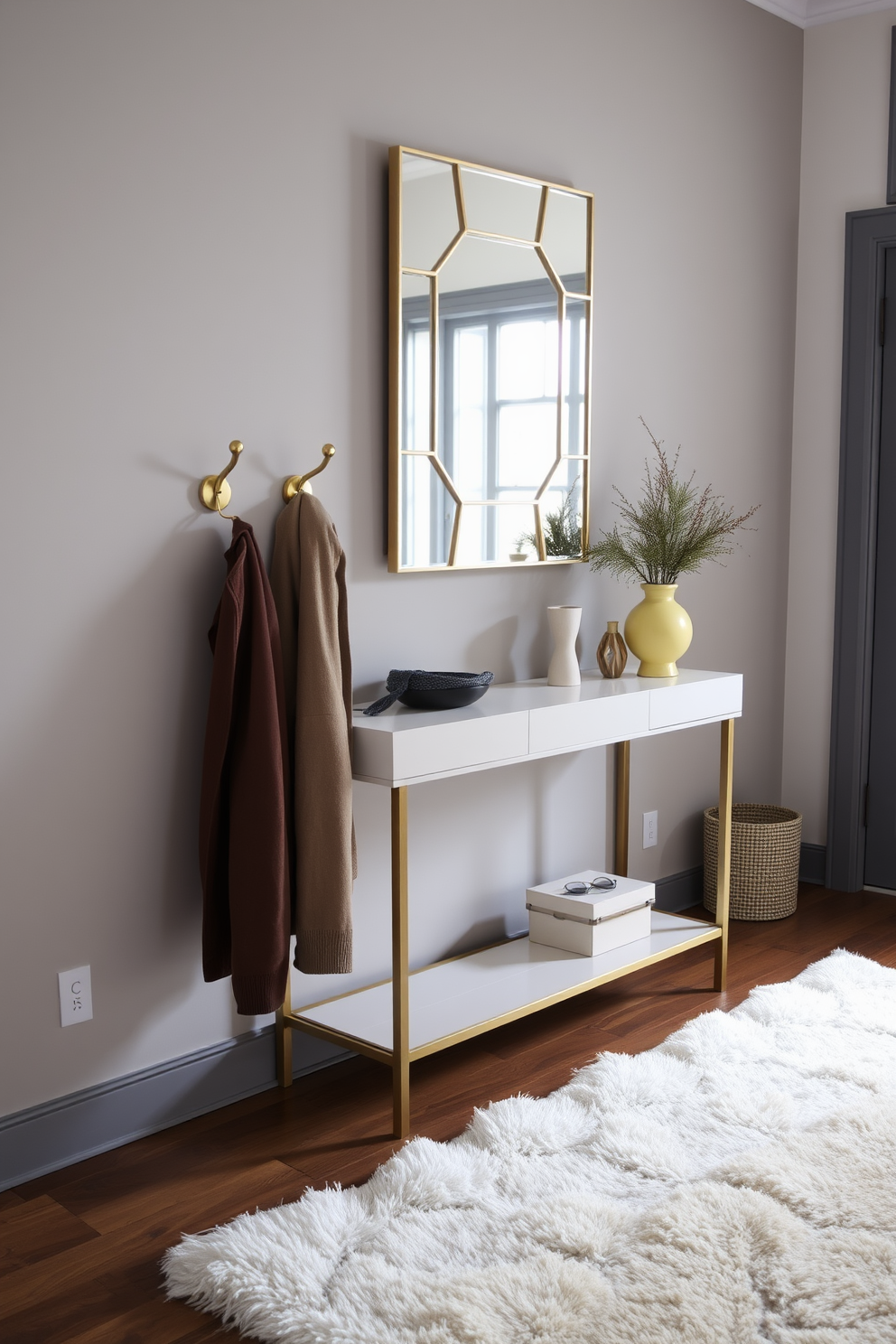 Functional coat hooks with style. The entryway features a sleek console table against the wall, adorned with a stylish mirror above it. The coat hooks are made of brushed brass, providing an elegant touch. A cozy rug lies beneath, adding warmth to the space while complementing the winter decor.