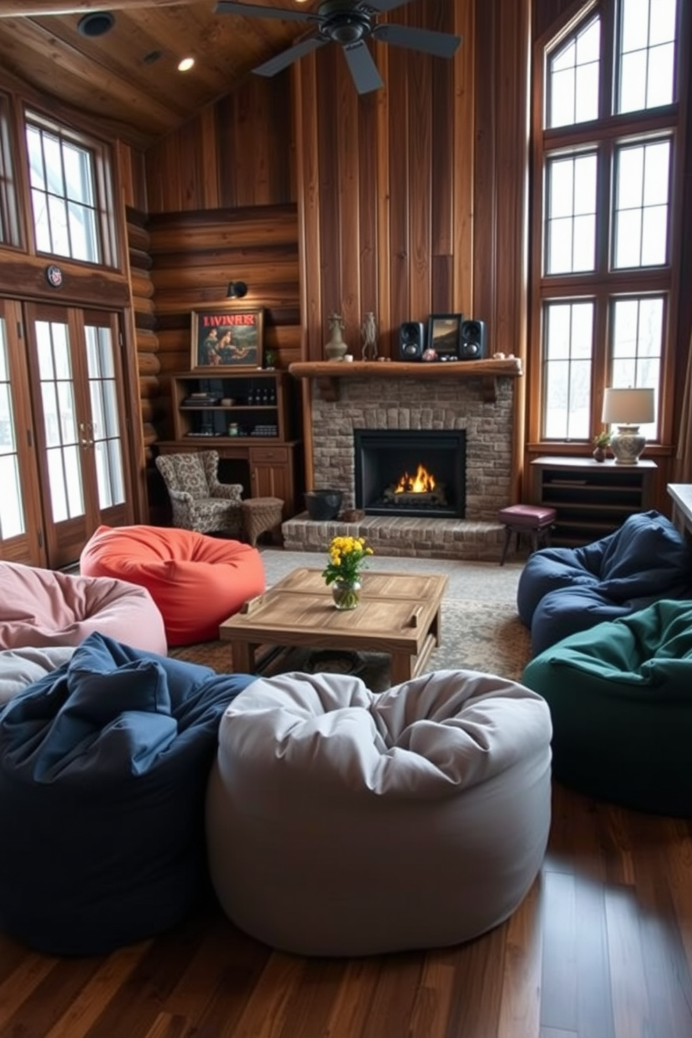 A cozy winter game room features oversized bean bags in various colors scattered around a central coffee table. The walls are adorned with rustic wood paneling, and a large fireplace adds warmth to the inviting atmosphere.