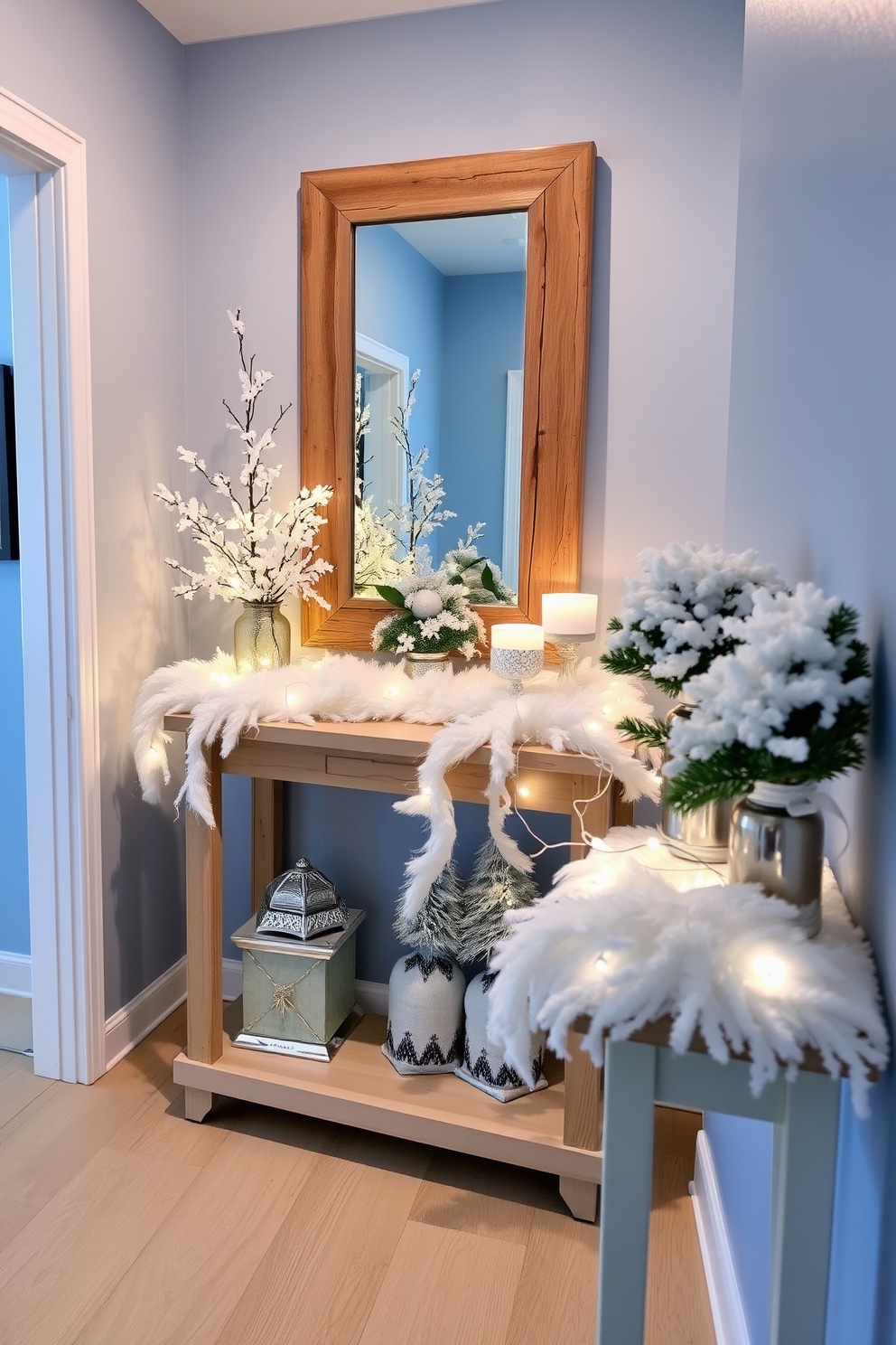 A winter hallway adorned with faux snow accents on surfaces creates a cozy and inviting atmosphere. The walls are painted in a soft blue hue, while the floor features a light wood finish that complements the winter theme. Decorative elements include white faux snow draped over a console table, along with twinkling fairy lights intertwined. A large mirror with a rustic wooden frame reflects the winter decor, enhancing the overall charm of the space.