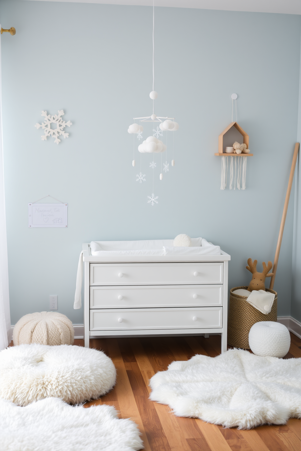 A cozy winter nursery adorned with faux snow on the windows creates a magical atmosphere. Soft pastel colors dominate the room, complemented by plush toys and a comfortable rocking chair in the corner. A whimsical mobile hangs above the crib, featuring snowflakes and winter animals. The walls are painted a gentle blue, and fluffy white rugs add warmth to the space.