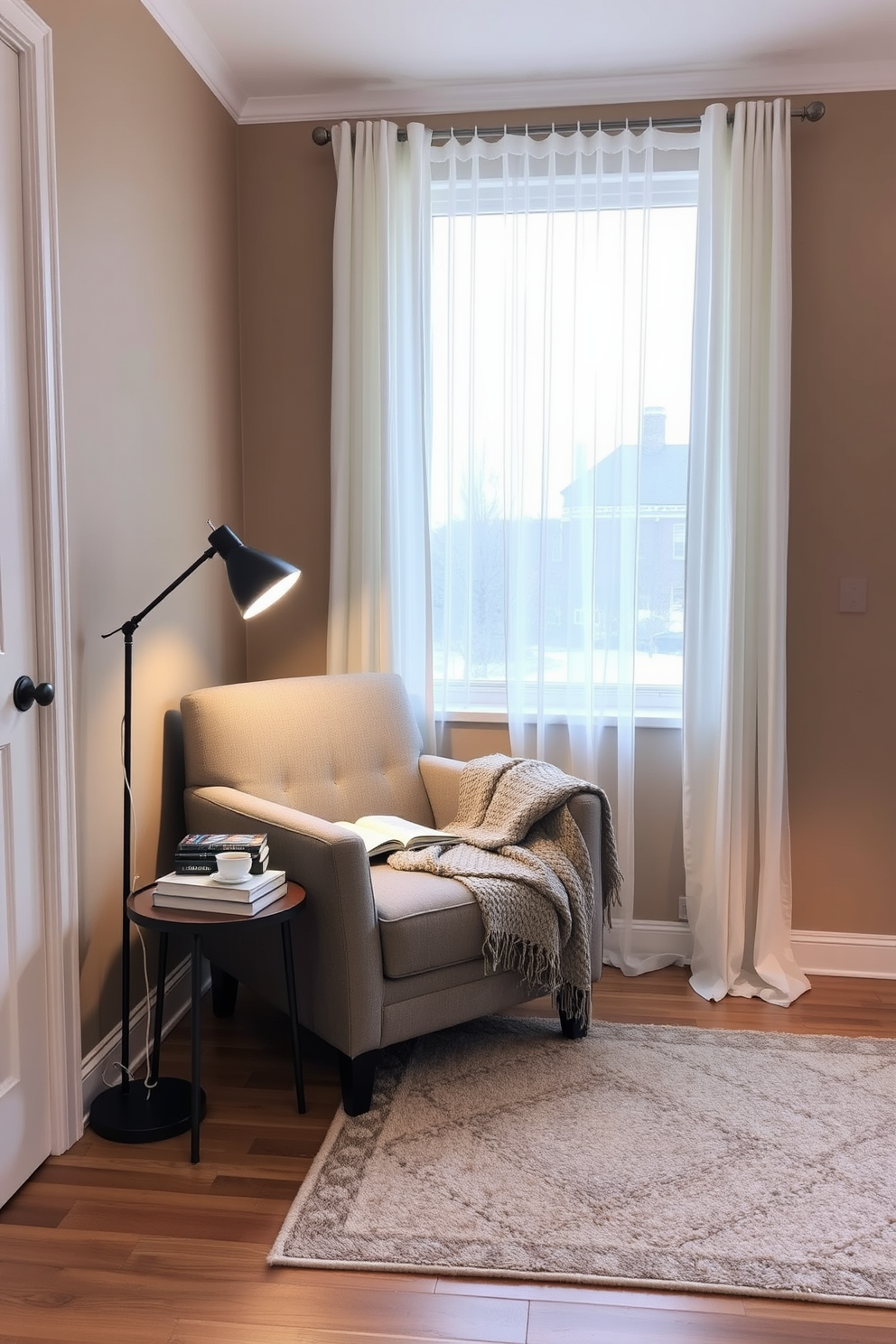 A cozy winter reading nook featuring a plush armchair in a soft gray fabric positioned next to a floor-to-ceiling window with sheer white curtains. A stylish reading lamp with adjustable brightness stands beside the chair, illuminating a small side table adorned with a stack of books and a steaming cup of tea. The walls are painted in a warm taupe color, creating a welcoming atmosphere, while a thick knit blanket drapes over the armchair inviting relaxation. A soft area rug in muted tones anchors the space, adding texture and warmth to the hardwood floor.