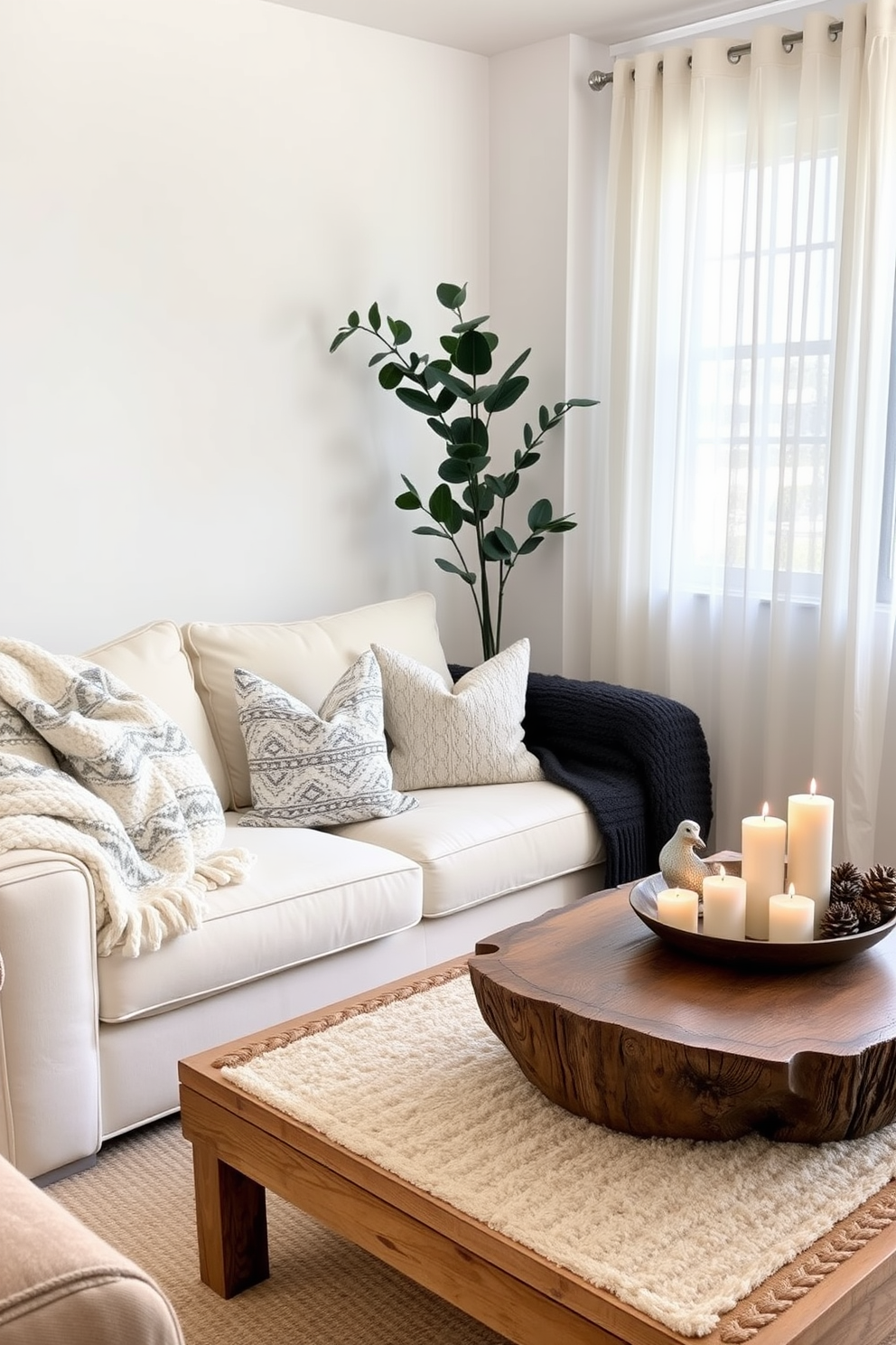 A cozy winter small living room features a plush cream sofa adorned with a mix of patterned throw pillows. A chunky knit blanket drapes over one arm, while a soft area rug anchors the space with warmth. In the corner, a rustic wooden coffee table holds a collection of candles and a decorative bowl filled with pinecones. A tall, leafy plant adds a touch of greenery, and sheer curtains allow soft natural light to filter in, enhancing the inviting atmosphere.