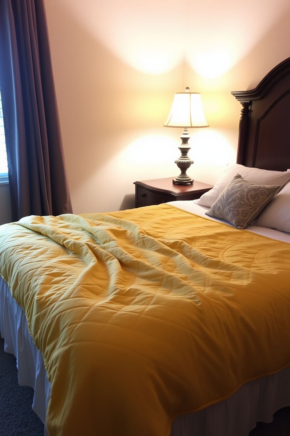 A cozy bedroom featuring a golden yellow quilt draped over a plush bed with soft pillows. The walls are painted in a warm cream tone, and a vintage wooden nightstand sits beside the bed adorned with a stylish lamp.