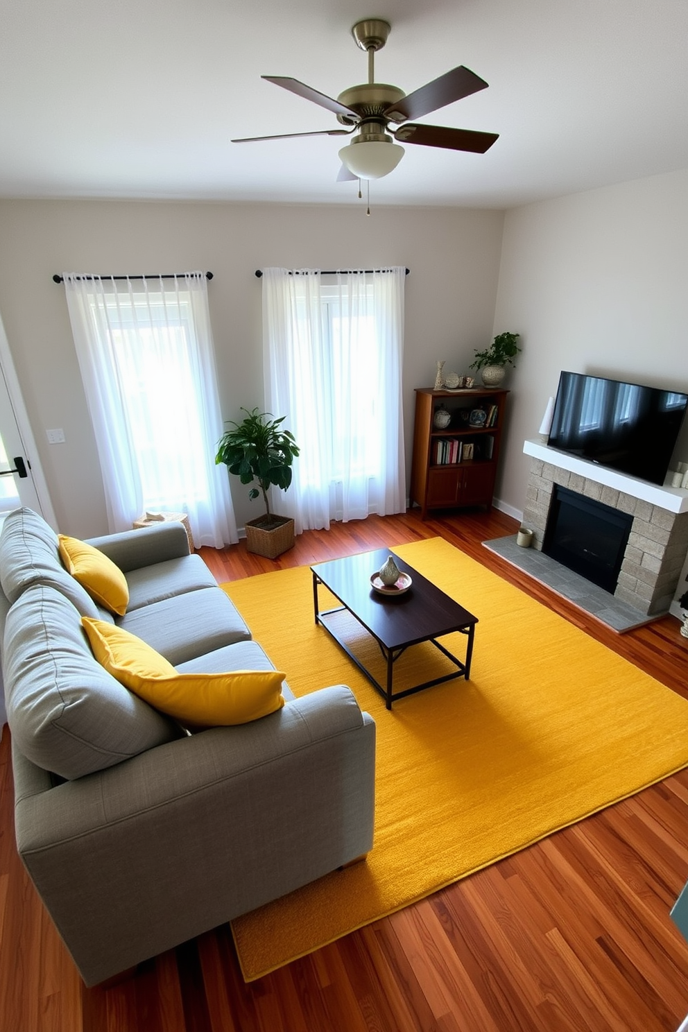 A bright and inviting family room features a harmonious yellow and gray color scheme that creates a sense of balance and warmth. The walls are painted a soft yellow, while the furniture includes a plush gray sectional sofa adorned with vibrant yellow throw pillows. Natural light floods the space through large windows, showcasing sheer gray curtains that gently frame the view. A stylish coffee table in the center is complemented by a yellow area rug that adds a cozy touch to the room.