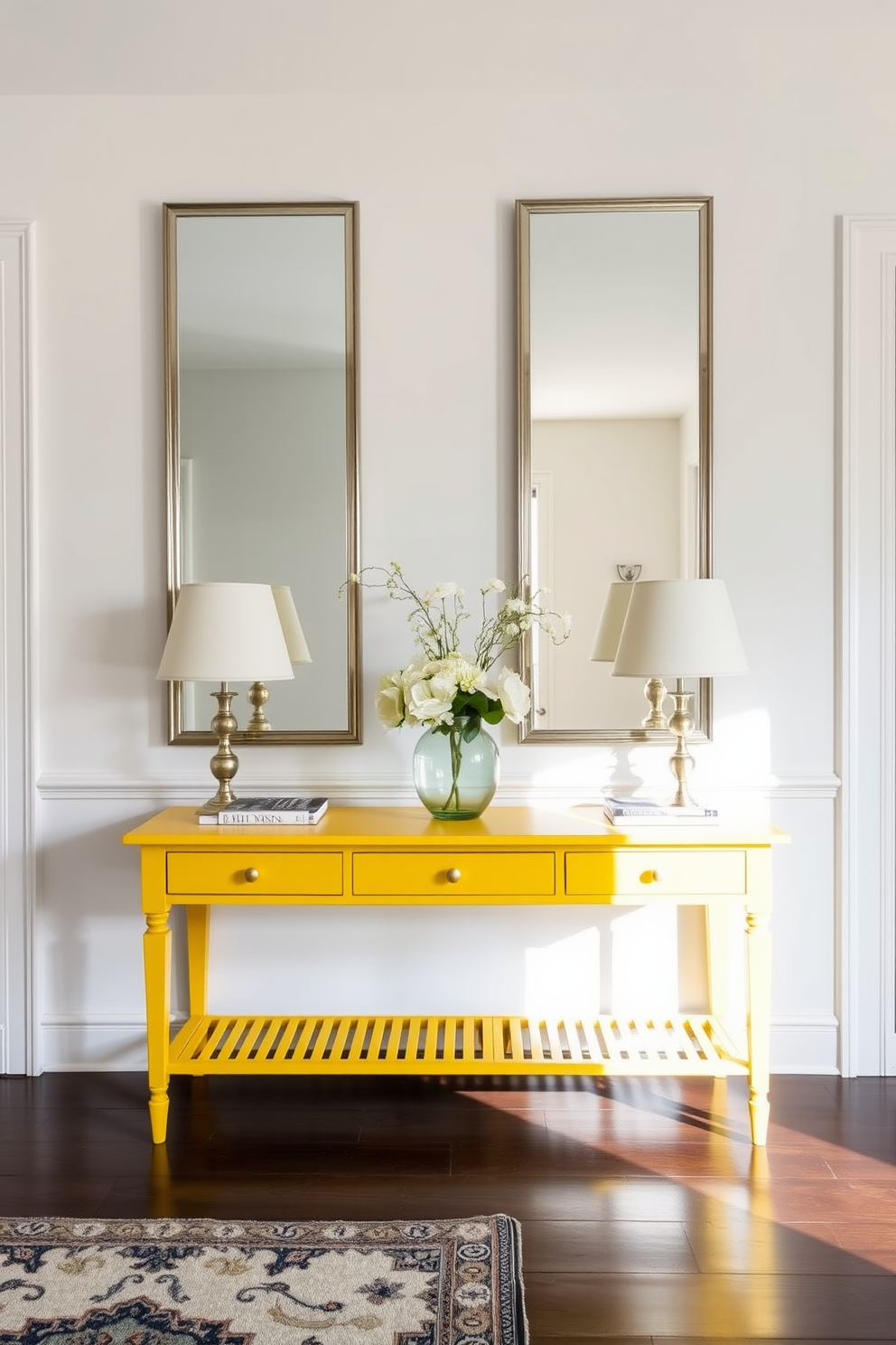 A bold yellow console table stands against the wall, reflecting light from the large mirrors that frame it. The foyer features a bright and inviting atmosphere, enhanced by complementary decor and a stylish rug beneath the table.