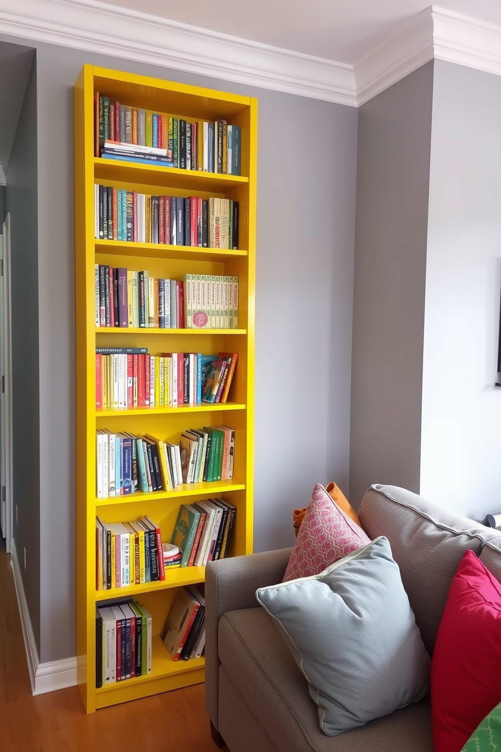 A bright yellow bookshelf stands prominently against the wall, filled with an array of colorful books that invite exploration. The living room features a cozy seating arrangement with a plush gray sofa and vibrant throw pillows that complement the cheerful bookshelf.