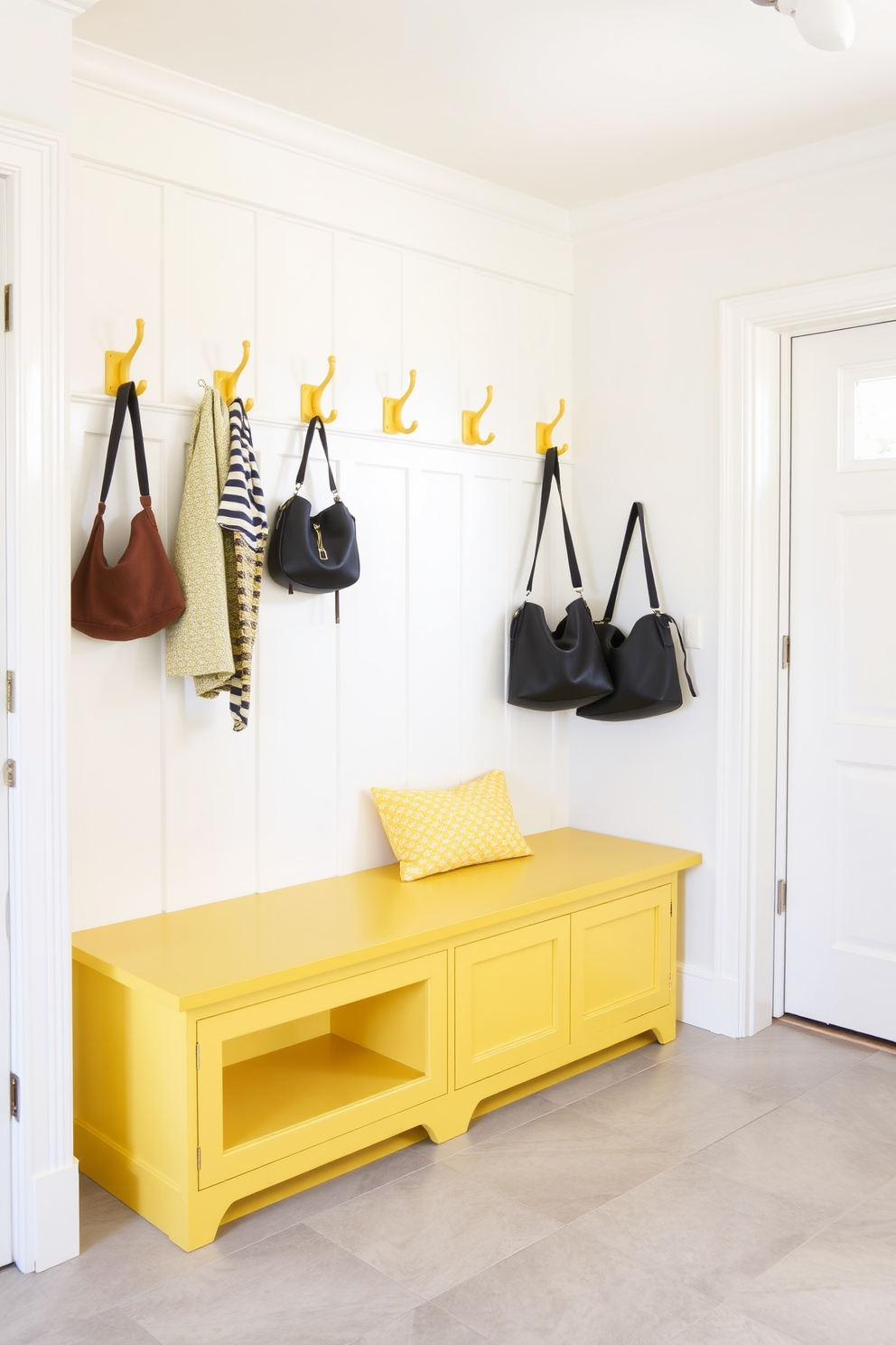 A charming mudroom features vintage yellow hooks mounted on a rustic wooden wall, perfect for hanging coats and bags. The floor is adorned with a patterned tile that complements the cheerful yellow accents, creating a welcoming atmosphere.