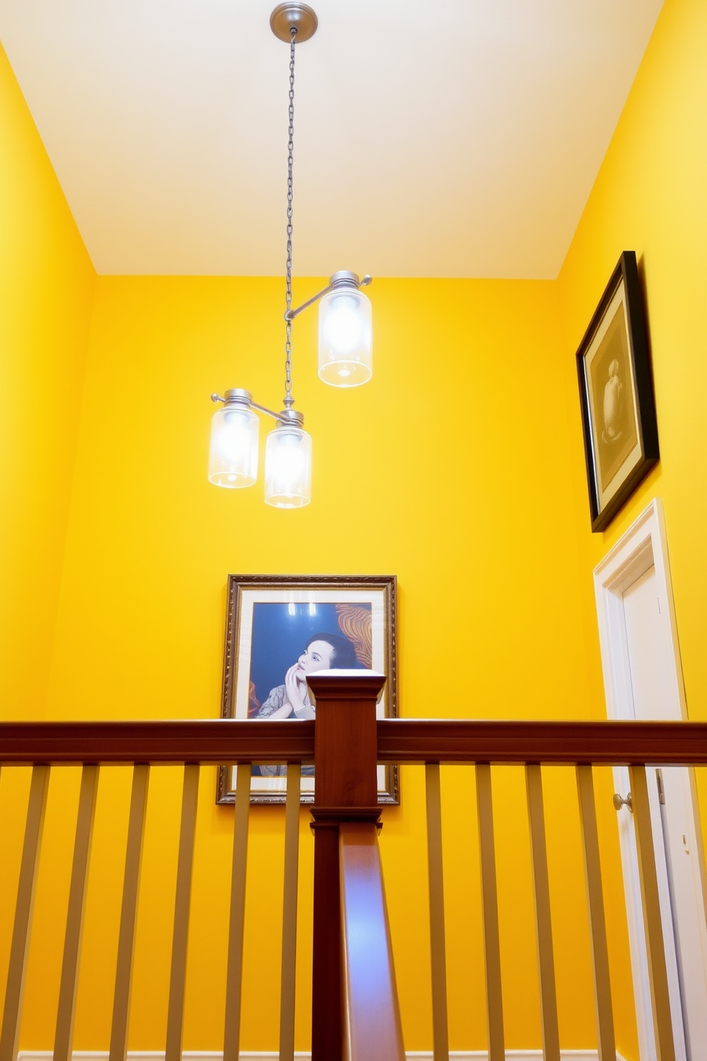 A sunny yellow staircase features elegant pendant lighting hanging gracefully above. The bright yellow walls create a warm and inviting atmosphere, complemented by the sleek wooden railing that adds a touch of sophistication.